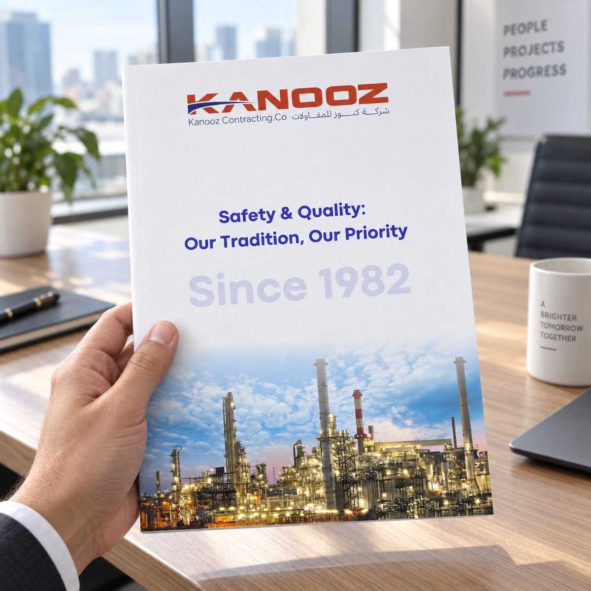 Company profile designed for Kanooz Contracting Co., held in hand with the cover visible
