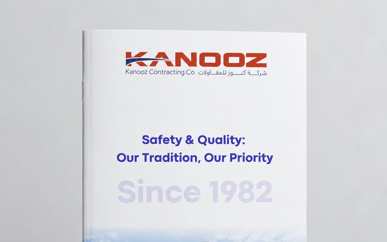 Company profile cover designed for Kanooz Contracting Co., shown as a printed brochure standing on a studio background